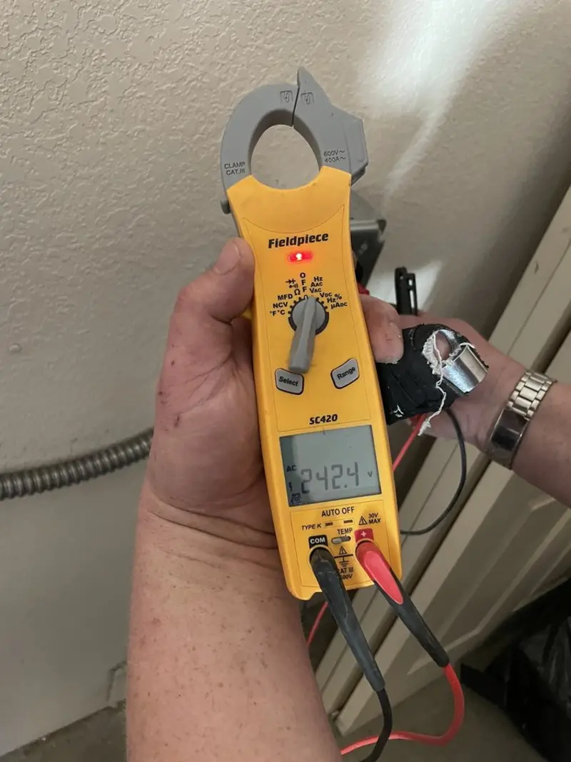 Voltage testing with clamp meter during Aluminum Wiring Replacement in Meadows Place